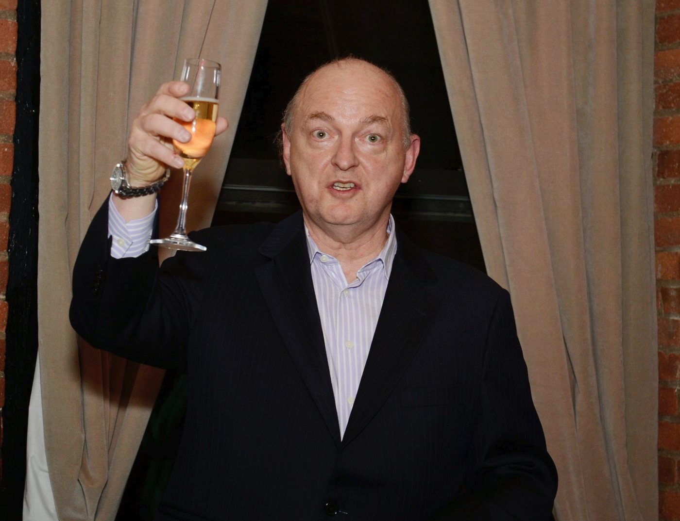 Dave Marsh raising a glass at a Kristen Ann Carr Fund benefit