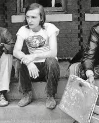 Dave Marsh as a young man in Detroit, sitting on a step